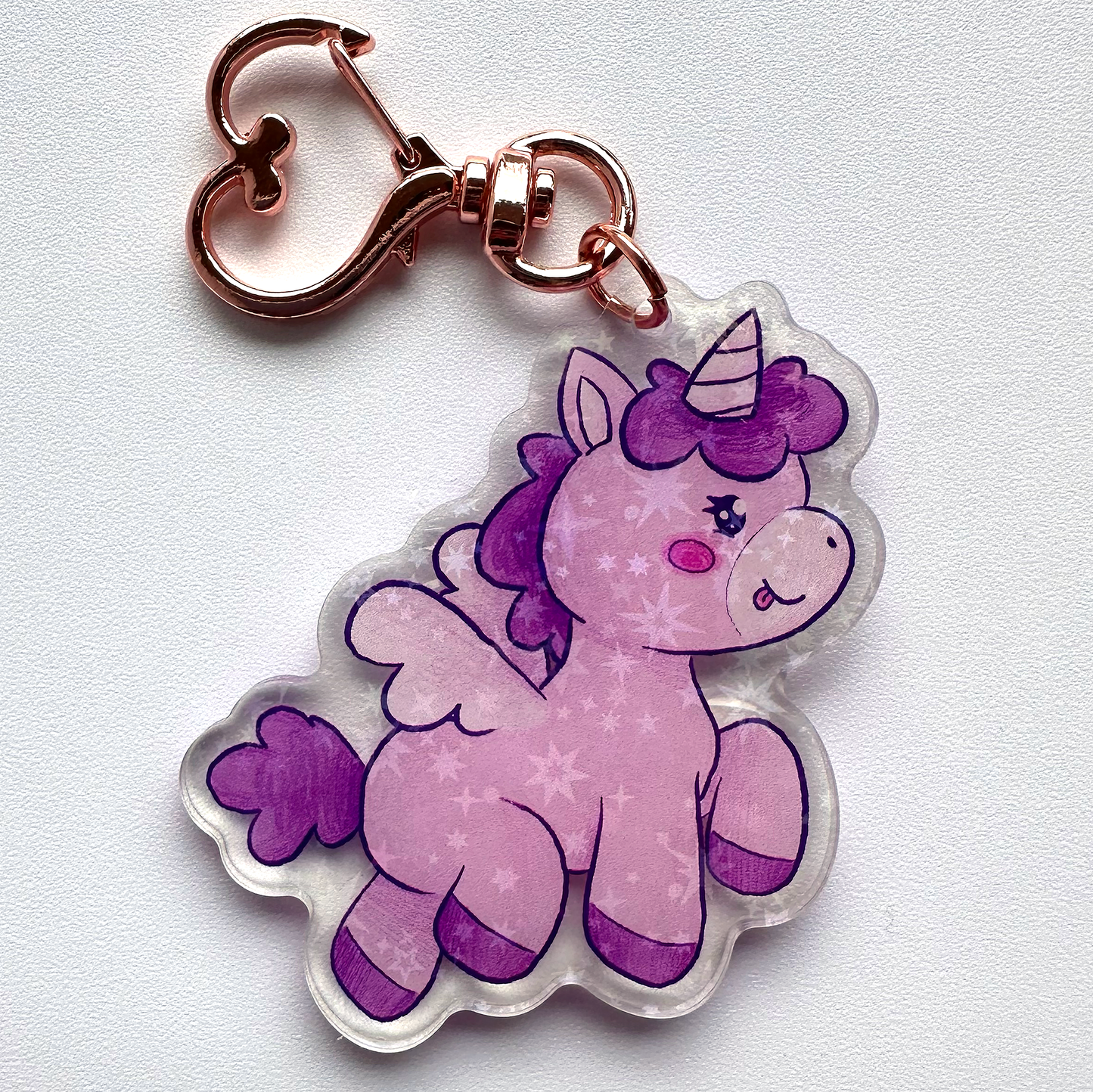 sparkly, acrylic, purple unicorn keychain with wings and rose gold heart clasp.